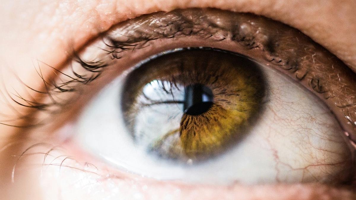 Why do people make odd facial expressions when self-administering eye drops?
