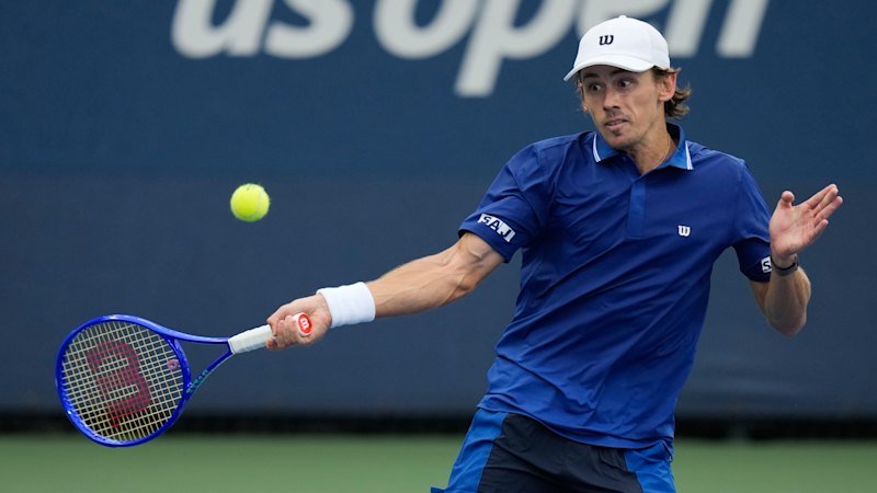 ‘Name of the game’: De Minaur adapts to New York deluge with fast win